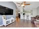 Spacious living room with wood floors, a ceiling fan, and an open layout, ideal for modern living at 915 Lockbreeze Dr, Davenport, FL 33897