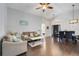 Open-concept living room boasts wood floors, high ceilings, and ample natural light, perfect for entertaining at 915 Lockbreeze Dr, Davenport, FL 33897