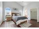 Spacious primary bedroom featuring hardwood floors, high ceilings, and arch windows providing ample natural light at 915 Lockbreeze Dr, Davenport, FL 33897