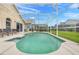 Sparkling screened-in pool surrounded by a spacious patio, offering a private oasis for relaxation and recreation at 915 Lockbreeze Dr, Davenport, FL 33897