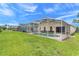 Expansive backyard featuring a screened pool, lush green lawn, and ample space for relaxation and entertaining at 915 Lockbreeze Dr, Davenport, FL 33897