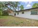 Backyard with a white-walled house and shed, providing ample outdoor space at 1002 Cypress Ave, Sanford, FL 32771