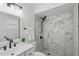 Modern bathroom with marble tiled shower, sleek fixtures, and a contemporary vanity at 1002 Cypress Ave, Sanford, FL 32771
