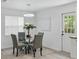 Bright dining area with a round glass table, stylish chairs, and a contemporary chandelier at 1002 Cypress Ave, Sanford, FL 32771