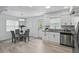 Cozy dining area with a glass table, comfortable seating, and natural light at 1002 Cypress Ave, Sanford, FL 32771
