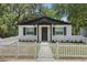 Charming home with a white picket fence, black trim, and beautiful curb appeal at 1002 Cypress Ave, Sanford, FL 32771