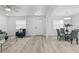 Bright, open-concept living and dining area with modern lighting, wood-look floors, and neutral decor at 1002 Cypress Ave, Sanford, FL 32771