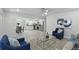 Spacious living area flowing into the kitchen, featuring stainless steel appliances and a dining area at 1002 Cypress Ave, Sanford, FL 32771