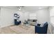 Inviting living room with neutral walls, comfortable seating, and a sleek glass coffee table at 1002 Cypress Ave, Sanford, FL 32771