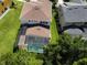 Aerial view of the house showing the pool and screened enclosure in the backyard at 1016 Fountain Coin Loop, Orlando, FL 32828