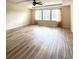 Spacious bedroom featuring wood flooring, a tray ceiling, and lots of natural light at 1016 Fountain Coin Loop, Orlando, FL 32828