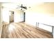 Spacious bedroom with wood-look flooring, ceiling fan, and access to additional space at 1016 Fountain Coin Loop, Orlando, FL 32828