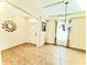 Inviting entryway with tile flooring, decorative mirror, and chandelier lighting fixture at 1016 Fountain Coin Loop, Orlando, FL 32828