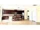 Expansive kitchen with stainless steel appliances, dark wood cabinets, and a granite-topped island at 1016 Fountain Coin Loop, Orlando, FL 32828