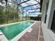 Sparkling backyard pool with brick pavers, adjacent to a screened lanai at 1016 Fountain Coin Loop, Orlando, FL 32828