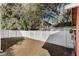 Fenced backyard with grass and mature trees offering privacy and shade at 1031 Kings Hwy, Kissimmee, FL 34744