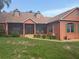 Charming single-story home with a screened-in porch, lush lawn, and colorful exterior paint scheme at 1031 Kings Hwy, Kissimmee, FL 34744