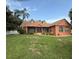Inviting single-Gathering home with well-manicured lawn, colorful exterior, and classic architectural details at 1031 Kings Hwy, Kissimmee, FL 34744
