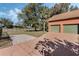 Attached two-car garage featuring green doors, a spacious driveway, and mature landscaping at 1031 Kings Hwy, Kissimmee, FL 34744