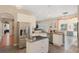 Bright kitchen features stainless appliances, central island with cooktop, granite countertops and tile flooring at 1031 Kings Hwy, Kissimmee, FL 34744