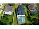 Aerial view of a home with a screened pool and lush green surroundings at 10747 Satinwood Cir, Orlando, FL 32825