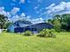 Beautiful backyard with screened-in pool and lush greenery offers a private outdoor retreat at 10747 Satinwood Cir, Orlando, FL 32825