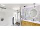 Modern bathroom featuring a dual sink vanity, unique mirrors, and a glass enclosed shower at 10747 Satinwood Cir, Orlando, FL 32825