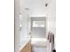 Clean bathroom featuring modern gold hardware, shower-tub combo, and neutral tile at 10747 Satinwood Cir, Orlando, FL 32825