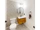 Stylish half bathroom with a modern vanity and decorative wall tiles at 10747 Satinwood Cir, Orlando, FL 32825
