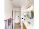 Bright bathroom features modern fixtures, double vanity, and a stylish, well-lit mirror at 10747 Satinwood Cir, Orlando, FL 32825