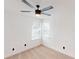 Bright bedroom boasts neutral carpet, ceiling fan, and large windows offering plenty of natural light at 10747 Satinwood Cir, Orlando, FL 32825