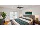 Bright bedroom with modern ceiling fan, French doors to pool, and neutral decor at 10747 Satinwood Cir, Orlando, FL 32825