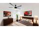 Cozy bedroom features modern ceiling fan, large windows, and neutral decor at 10747 Satinwood Cir, Orlando, FL 32825