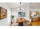 Elegant dining room featuring a modern chandelier and ample seating for gatherings at 10747 Satinwood Cir, Orlando, FL 32825