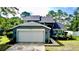 A lovely two-story home featuring a two-car garage and well-manicured landscaping at 10747 Satinwood Cir, Orlando, FL 32825