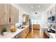 Modern kitchen with stainless steel appliances, light wood cabinets, and marble countertops at 10747 Satinwood Cir, Orlando, FL 32825