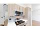 Updated kitchen features stainless steel appliances and modern cabinetry at 10747 Satinwood Cir, Orlando, FL 32825