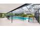 Spacious screened-in pool area offers a large patio for entertaining and lush landscaping at 10747 Satinwood Cir, Orlando, FL 32825