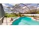 Beautiful screened-in pool area includes a spa, mature landscaping, and a spacious patio at 10747 Satinwood Cir, Orlando, FL 32825