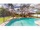 Sparkling pool with screened-in lanai and lush landscaping at 10747 Satinwood Cir, Orlando, FL 32825