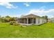 Spacious backyard showcasing the home's exterior and inviting screened lanai at 10828 Cherry Oak Cir, Orlando, FL 32817