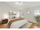 Primary bedroom featuring wood laminate flooring, a ceiling fan and a king size bed at 10828 Cherry Oak Cir, Orlando, FL 32817