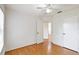A well-lit bedroom with wood floors and a hallway view at 10828 Cherry Oak Cir, Orlando, FL 32817