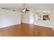 Large living room with laminate wood flooring and a view into the kitchen at 10828 Cherry Oak Cir, Orlando, FL 32817