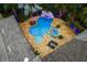 Aerial view of a backyard oasis featuring a unique pool, spa, waterfall, and meticulously manicured landscaping at 11106 Coniston Way, Windermere, FL 34786