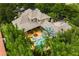 Aerial view showcases the home's sprawling layout, pool, spa, and lush landscaping at 11106 Coniston Way, Windermere, FL 34786