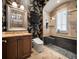 Bathroom with decorative wallpaper, glass shower and dark wood cabinets at 11106 Coniston Way, Windermere, FL 34786