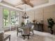 Charming dining room with chandelier, built-in buffet, and large window with landscaped view at 11106 Coniston Way, Windermere, FL 34786