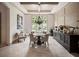 Formal dining room boasts wainscoting, coffered ceiling, elegant chandelier, and large windows at 11106 Coniston Way, Windermere, FL 34786