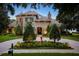 Stately two-story home with stone accents, lush landscaping, fountain and circular driveway at 11106 Coniston Way, Windermere, FL 34786